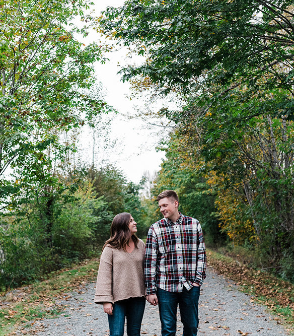 a couple strolls along a trail together in North Bend during the fall season with Seattle elopement photographer Amy Galbraith