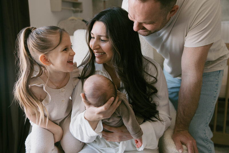 fresh 48 newborn session at home in nursery with older sister and mom and dad.