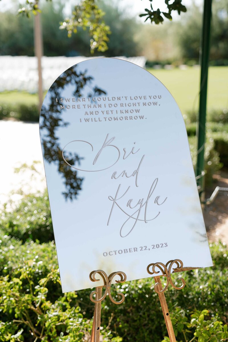 Welcome sign at wedding engraved with couples name in calligraphy. 