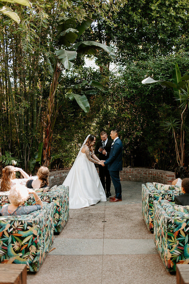 Miranda and Phillip during their garden wedding surrounded by greenery, planned by Beyond the Event and photographed by Desert Born Studios.