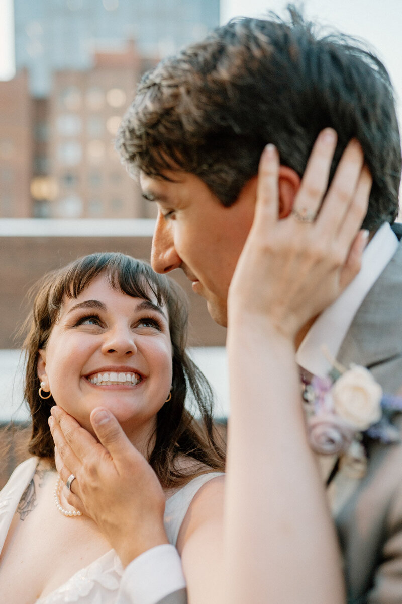 Bride smiling at groom during rooftop moment