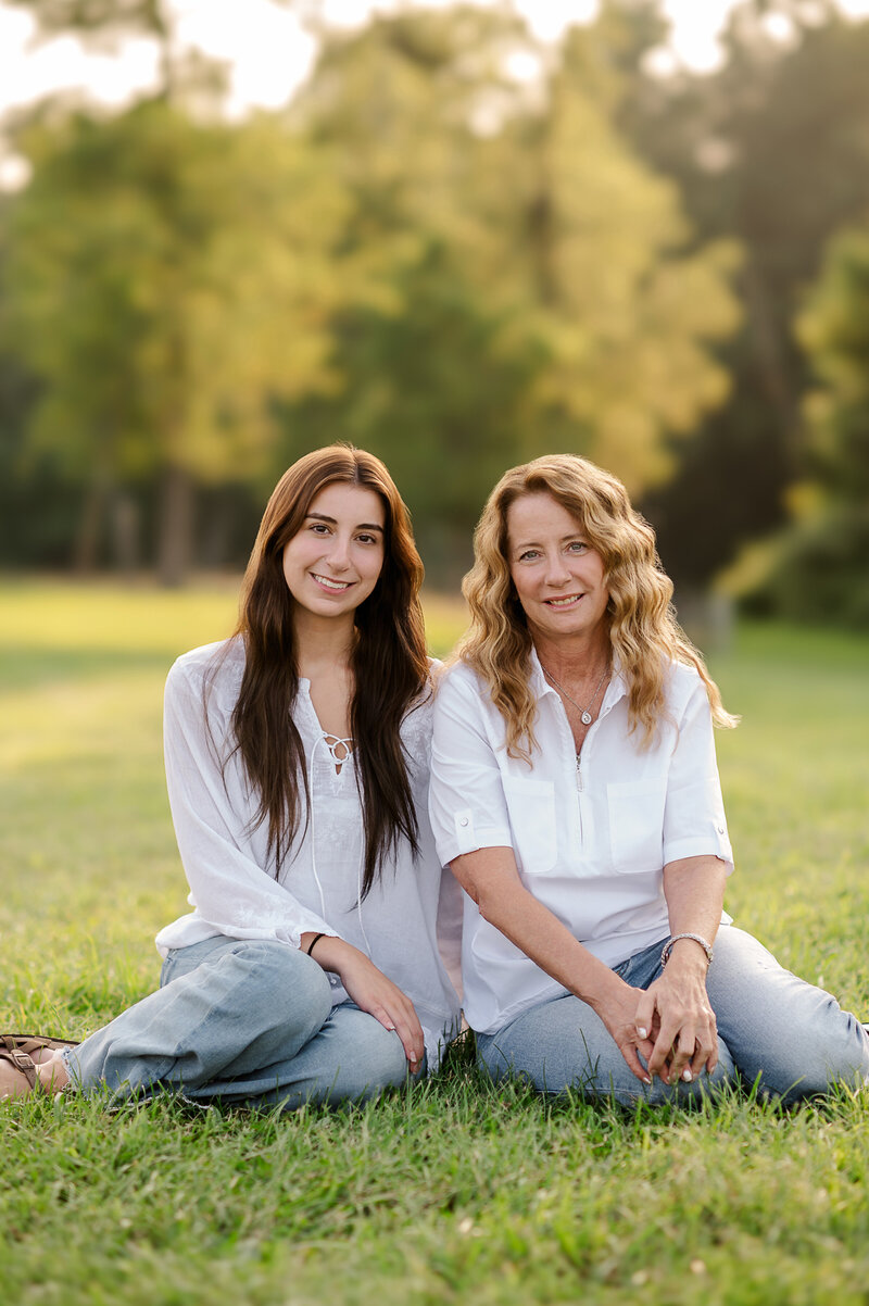Mother and daughter sitting close together, smiling during a relaxed family session in Harrisburg, PA