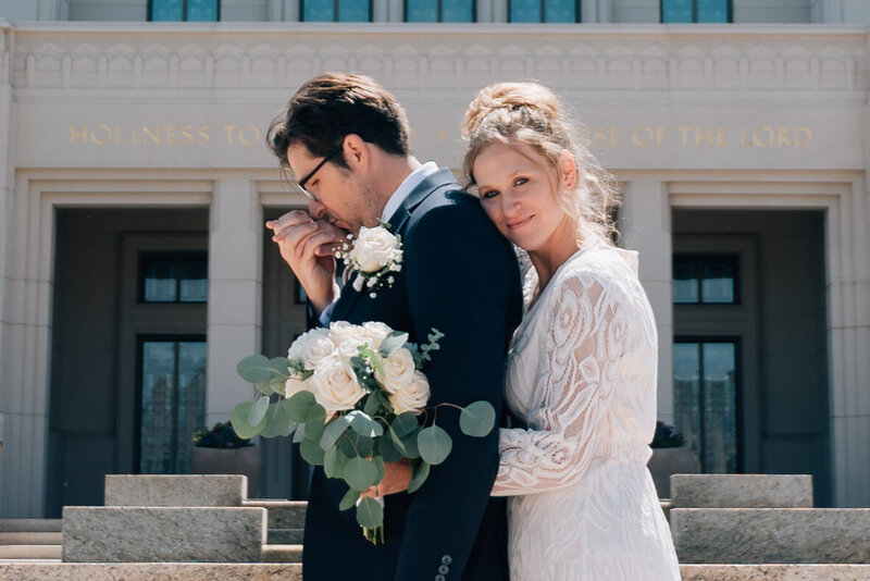 Stealing kisses during their wedding at the LDS Oakland Temple in Oakland, California