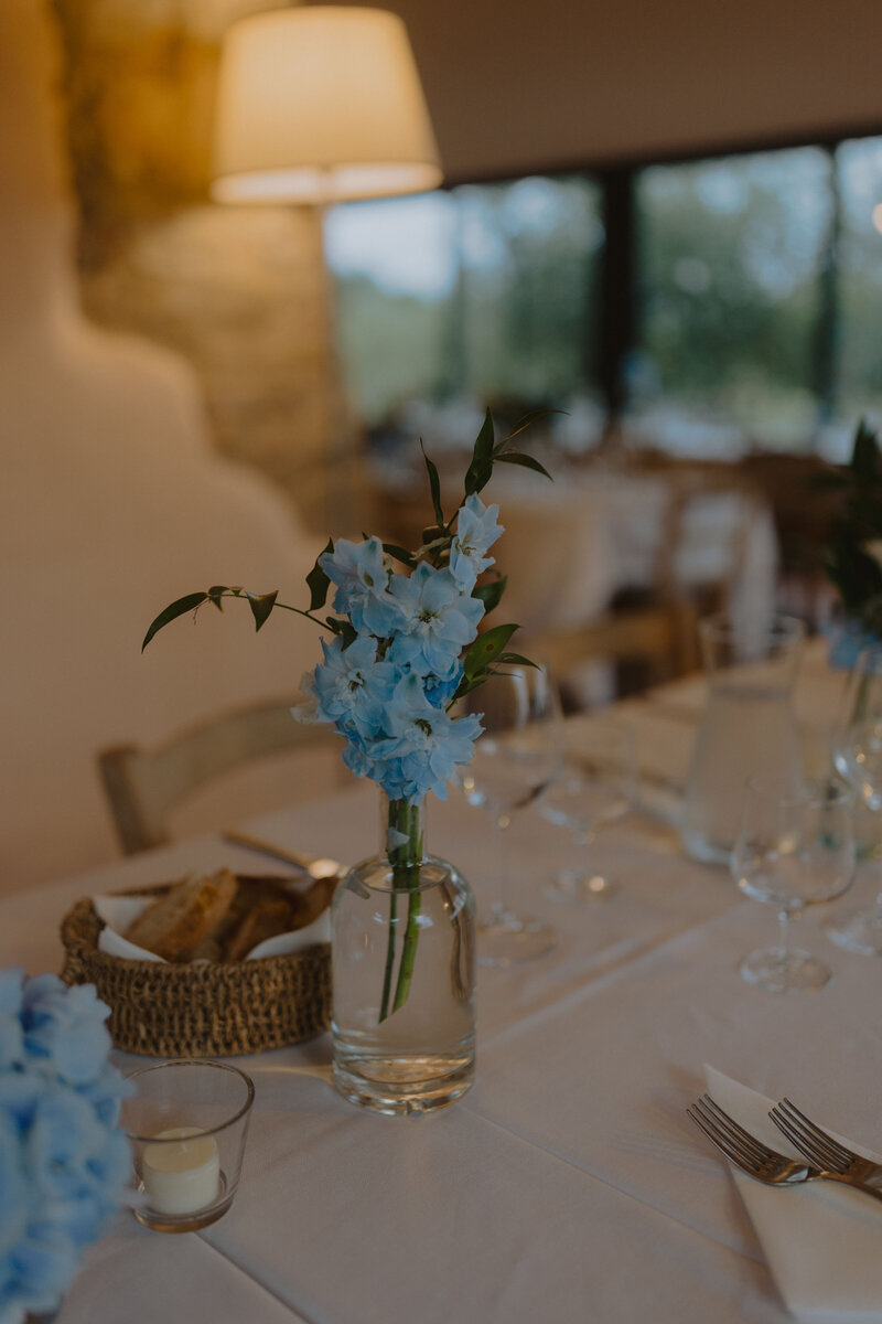 A high-end wedding reception setup in a dreamy destination, where refined décor, delicate floral installations, and crystal glassware create a timeless aesthetic.