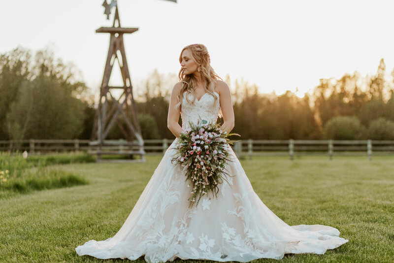bride posing by windmill