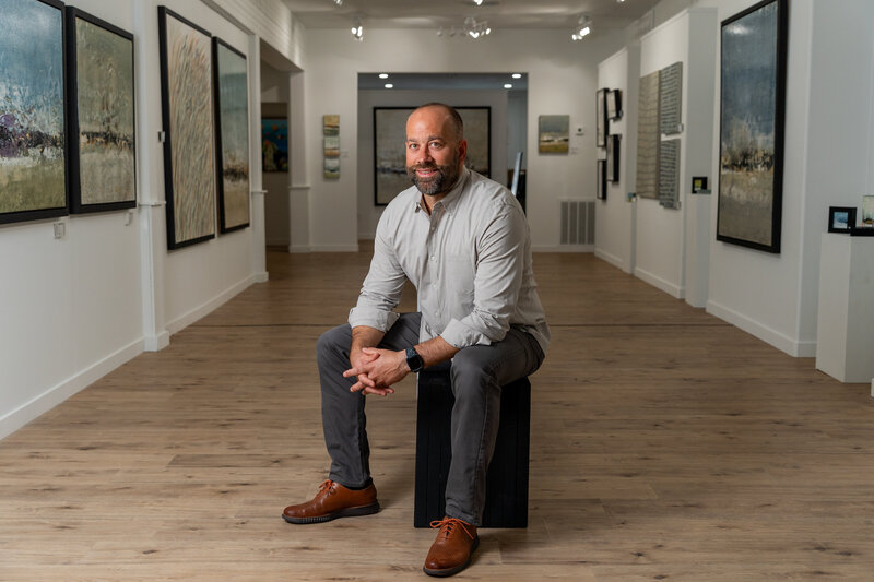 Meet Brad Robertson, the esteemed owner of Robertson Gallery, located in downtown New Port Richey, Florida. Captured by Lux Content Co., this image showcases Brad in his element, reflecting his passion for art and dedication to curating exceptional collections. The Robertson Gallery is a cultural gem in New Port Richey, offering a diverse range of artwork and fostering a vibrant artistic community. Discover the visionary behind the gallery and the artistry that makes it a cornerstone of the local art scene.