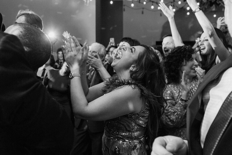 Wedding guests cheering and laughing together 
