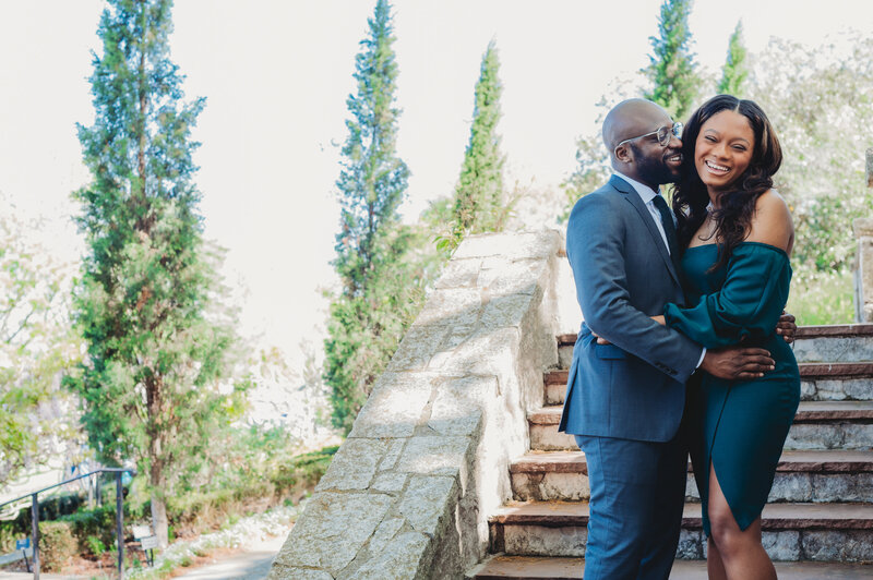 black couple engagement photoshoot at Dallas arboretum botanical garden wearing green dress and navy blue suit portrait photo taken by blessing daniel photography