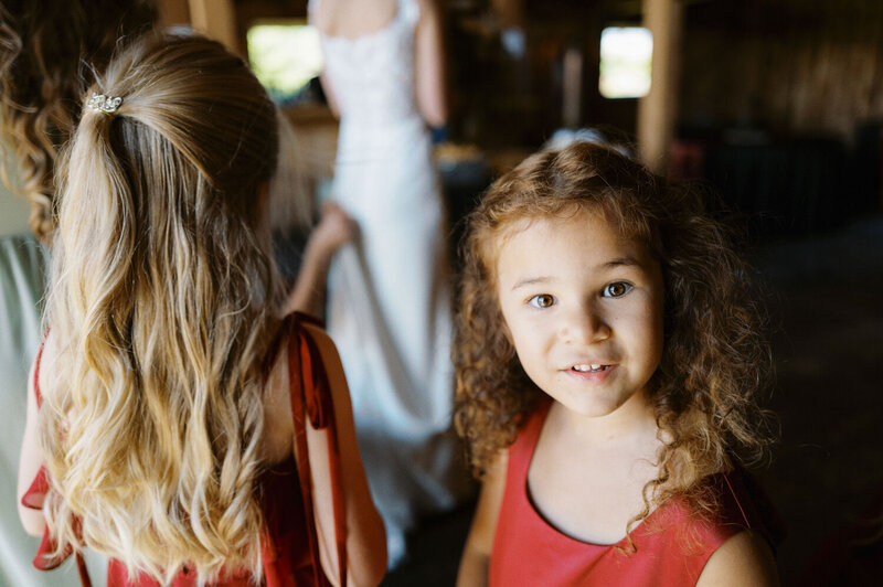 Flower girl smiles at the camera