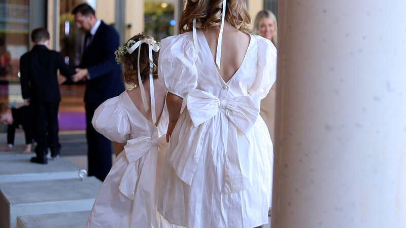 Bridesmaides play outside the historical  building in Brisbane before a wedding.