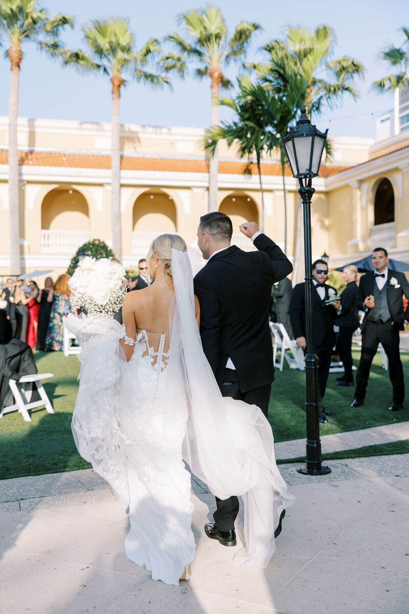 Bride and groom with back to the camera entering their wedding party