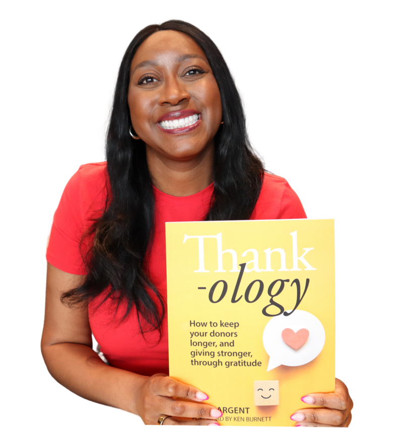 Woman smiling holding book title "Thank-ology"