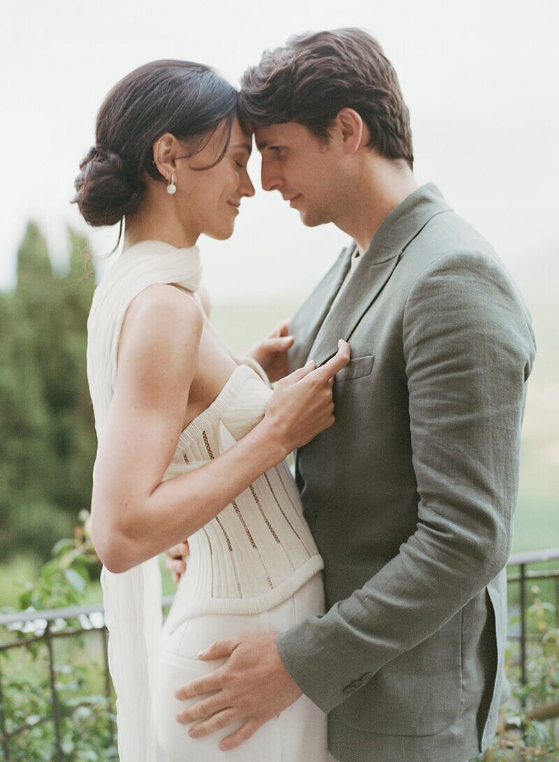 East Coast wedding couple posing overlooking the grounds below
