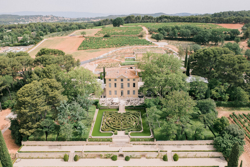 The gardens of Château de la Gaude in Aix-en-Provence with a distant view of the landscaped terraces
