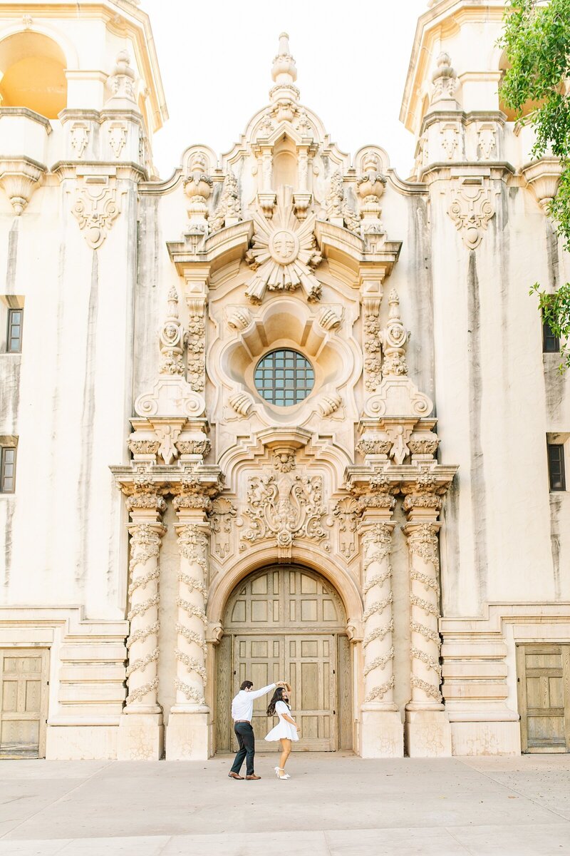 Groom spinning bride at Balboa Park in San Diego, California.