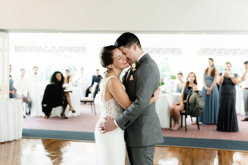 bride and groom embracing during firs dance at Iroquois Boating and Fishing Club