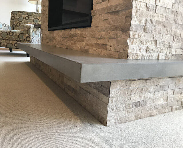 Concrete floating hearth with stone surround
