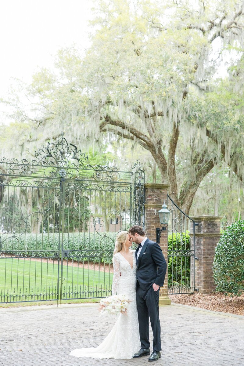 bride + groom running through tunnel of guests as they throw rose petals