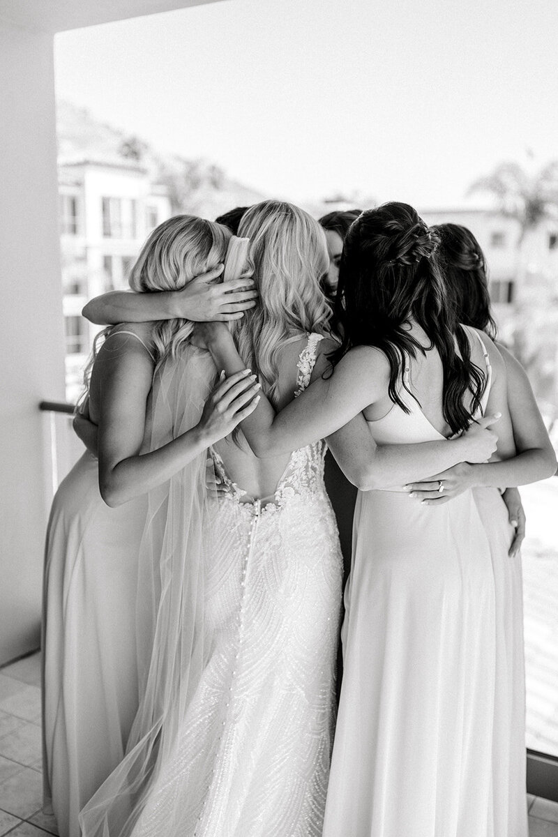 Tiffany Longeway Photography captures a touching embrace among the bridal party at The Ritz-Carlton Bacara in Santa Barbara. This elegant black and white photo highlights the deep bonds and emotional connections that make wedding days so special. Perfect for couples seeking a luxurious and intimate venue that enhances the beauty and significance of their wedding moments.