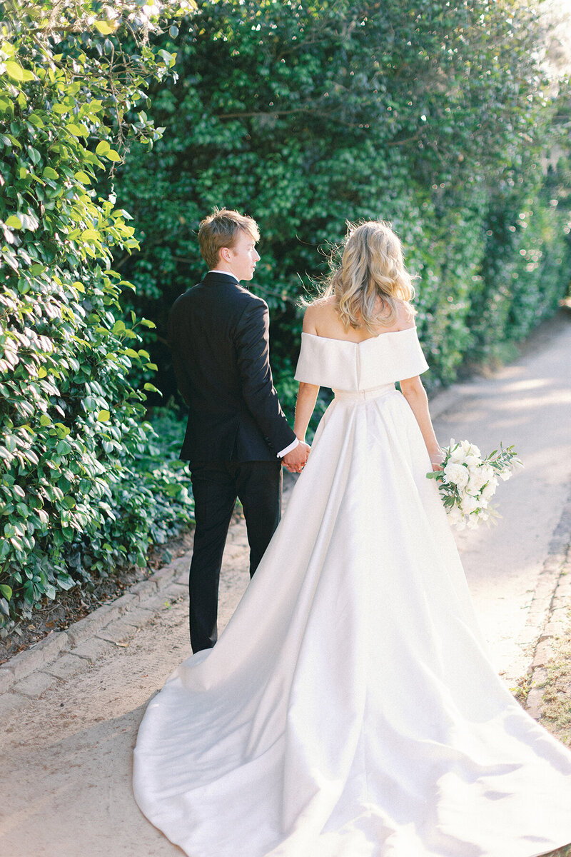 Married Couple holding hands walking in the garden