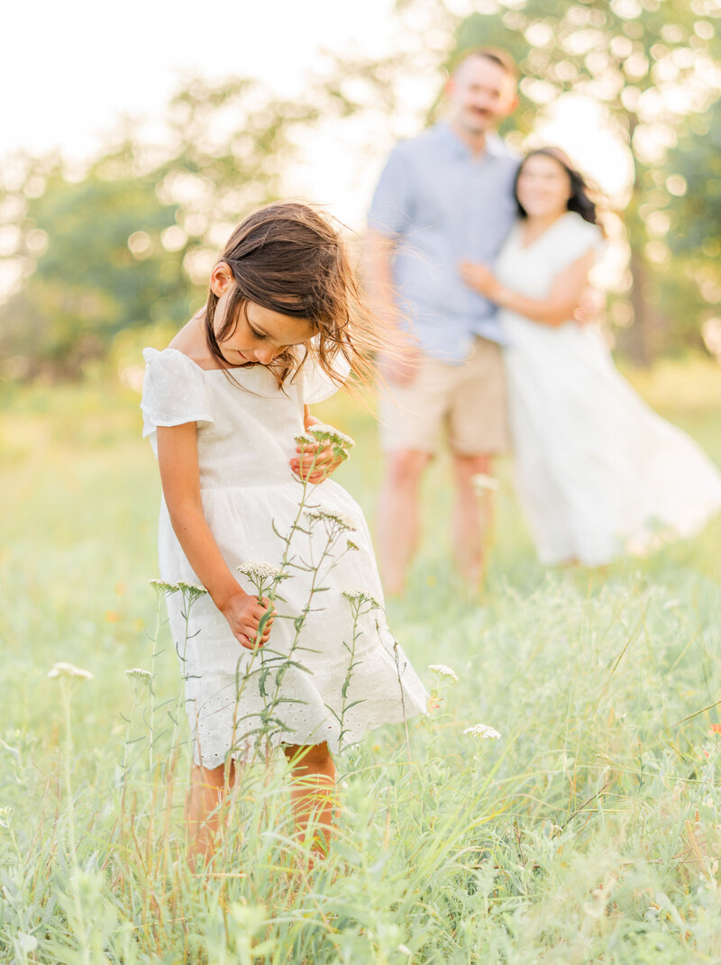 little girl close up holding flower