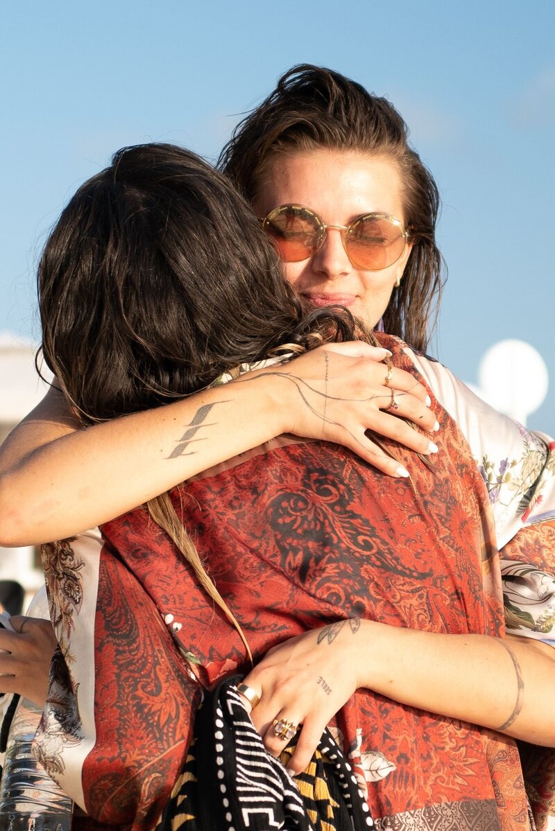 Two female friends hugging and  celebrating