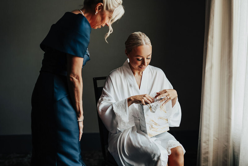 bride opening sentimental gift on wedding day