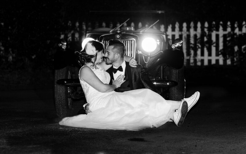 Bride & Groom in front of antique car at night