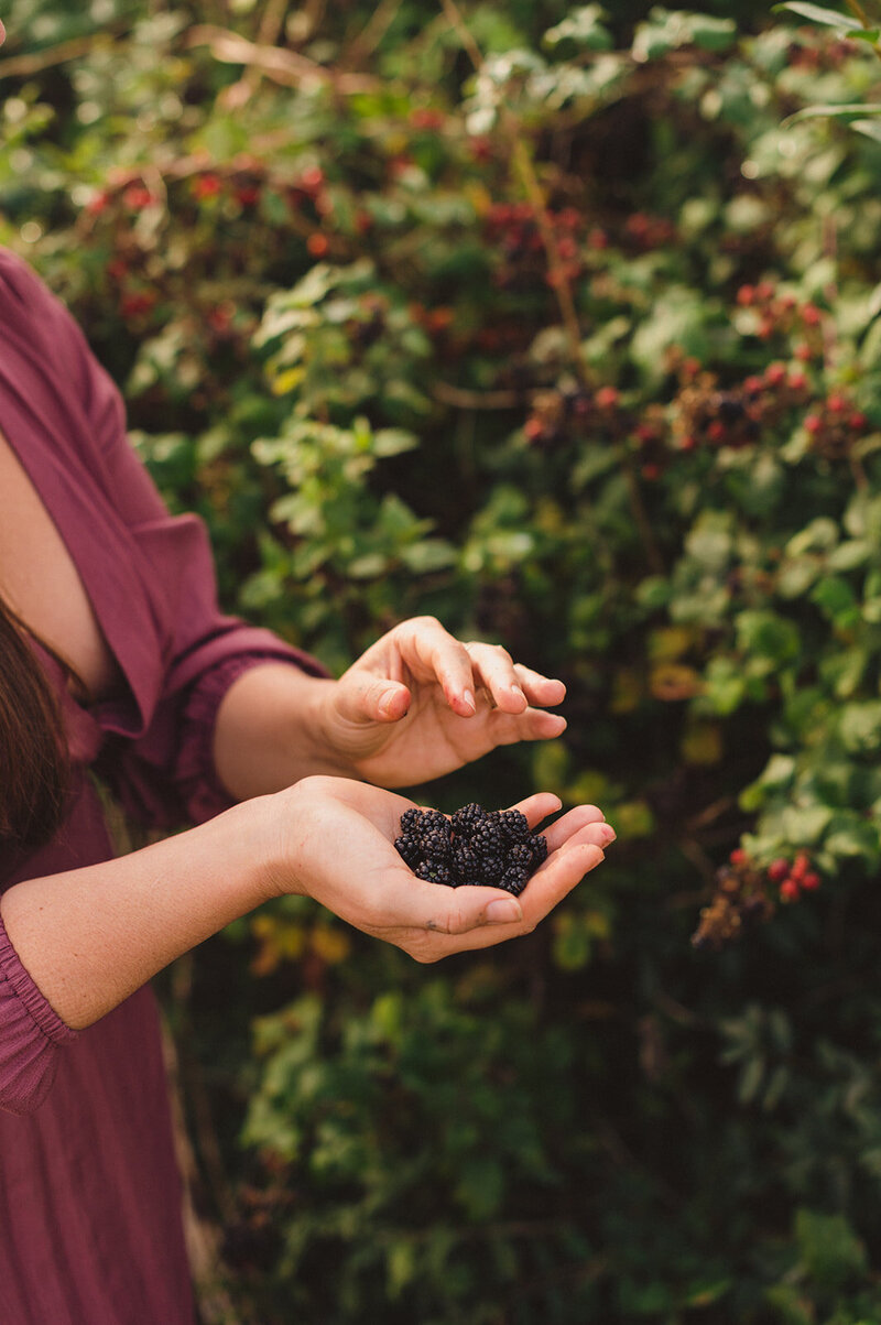 Miriam holding berries in hand