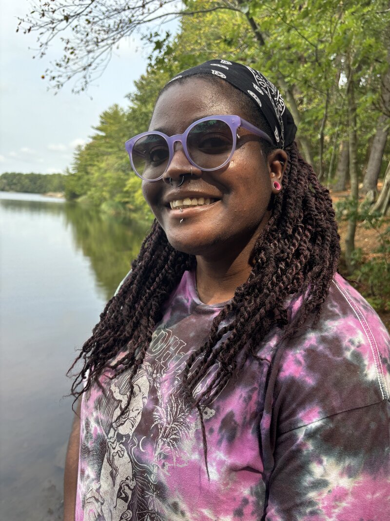 Sam, an educator at Brave Nature School, interacting with children during outdoor activities, encouraging exploration and learning in nature.