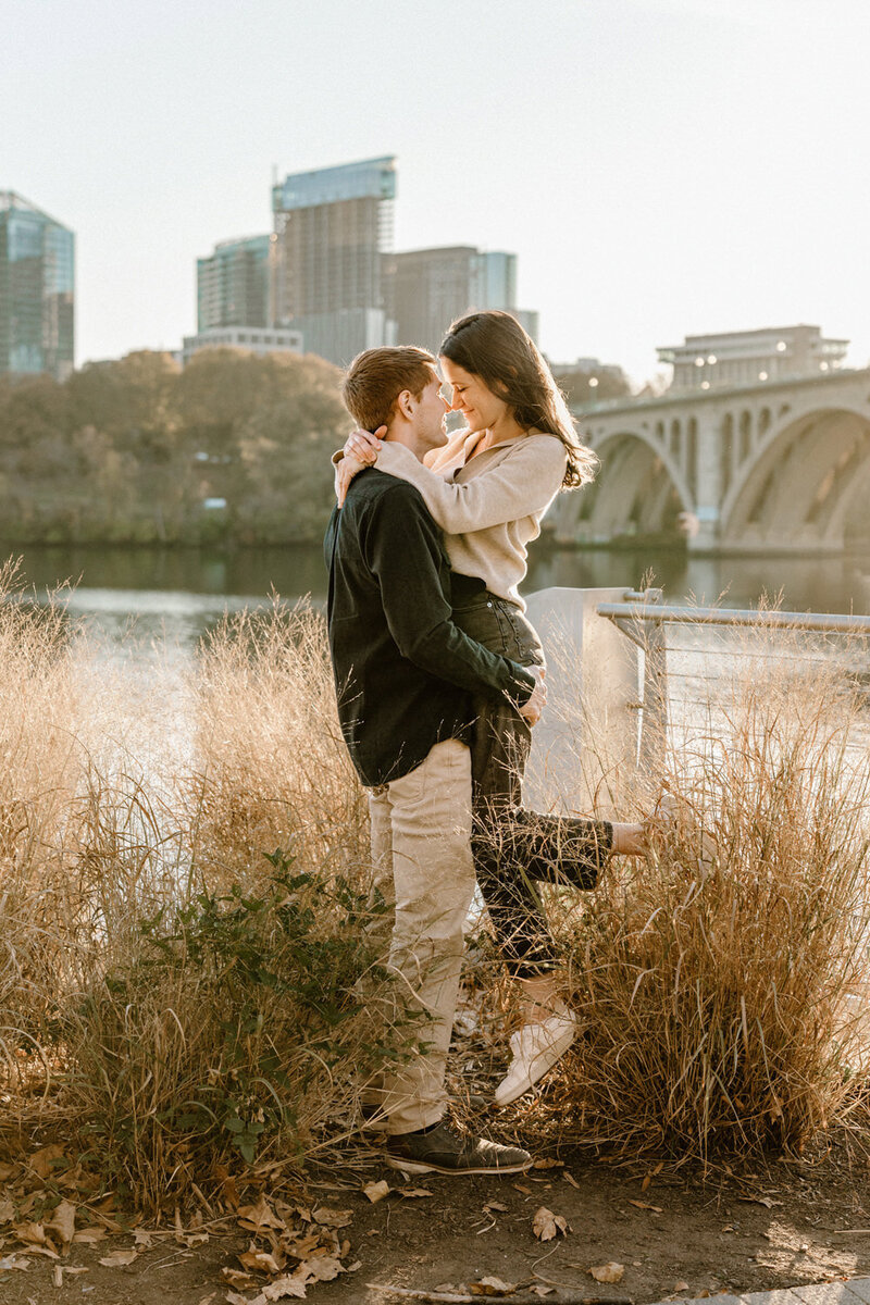 man holding up woman