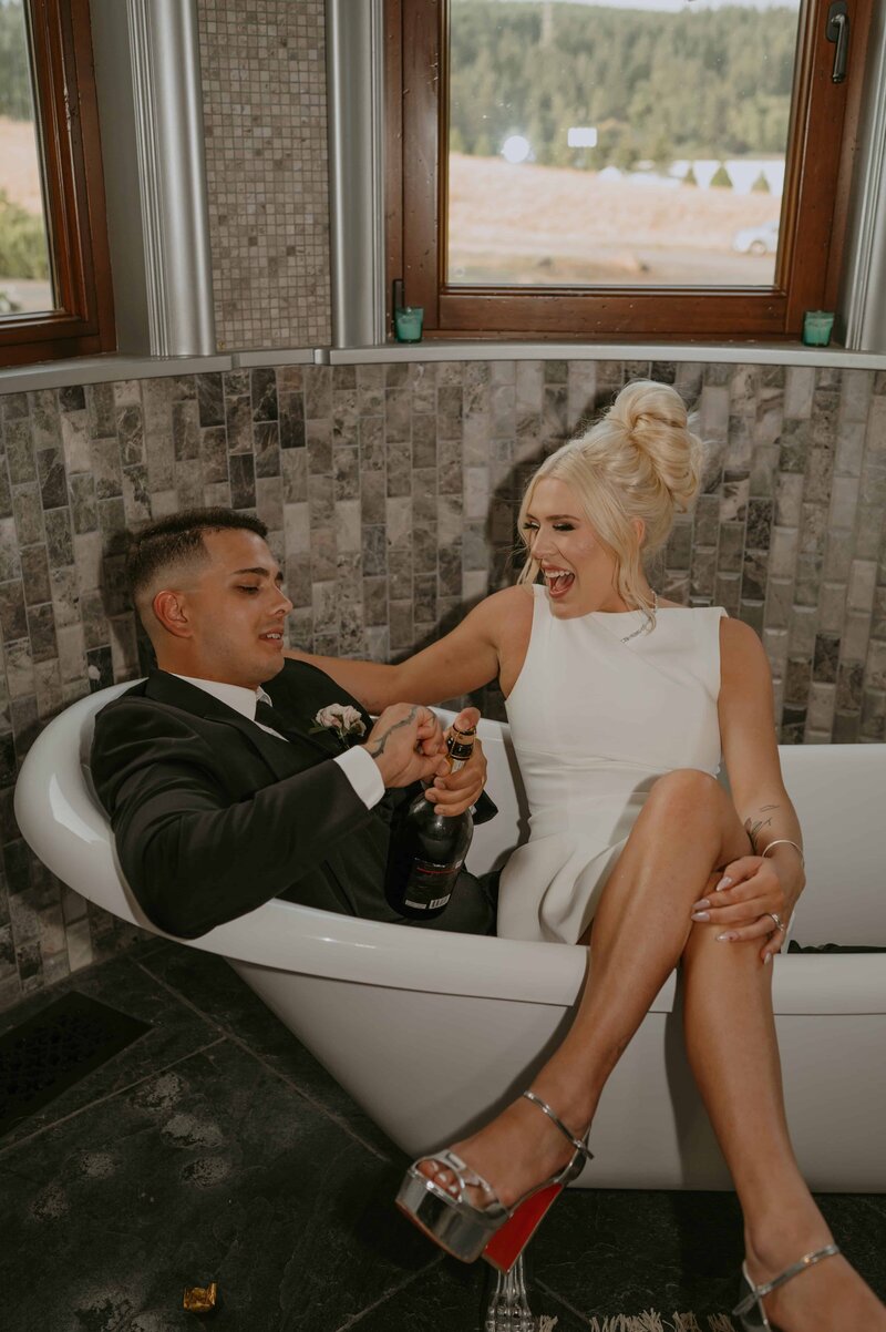 couple popping champagne after getting married in Portland, OR
