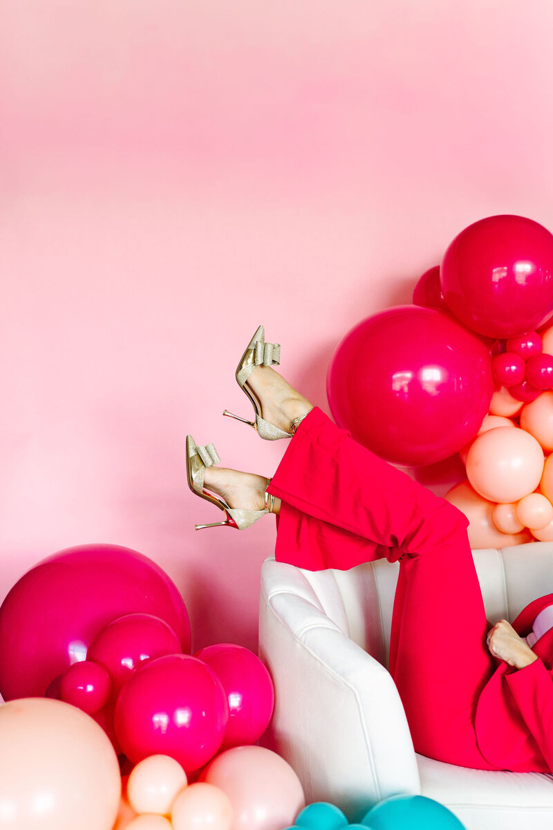 The Balloon Expert at Air with Flair Decor, adorned in a charming pink dress, sharing magical moments with her daughter. Our expert team brings a personal touch to balloon artistry, creating joyous experiences for all.
