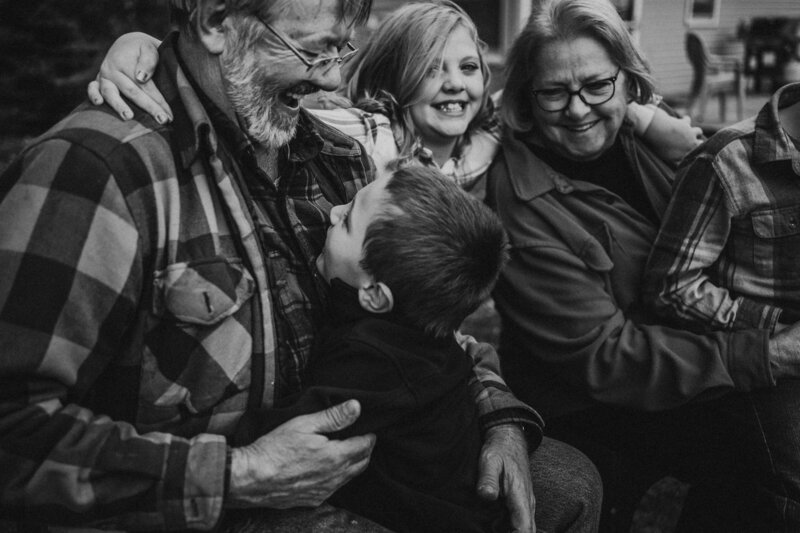 grandson gives bear hug to grandpa _bnw