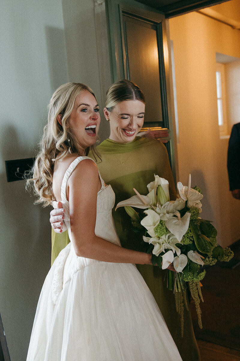 bride and bridesmaid embracing before the wedding ceremony in jekyll island, georgia 