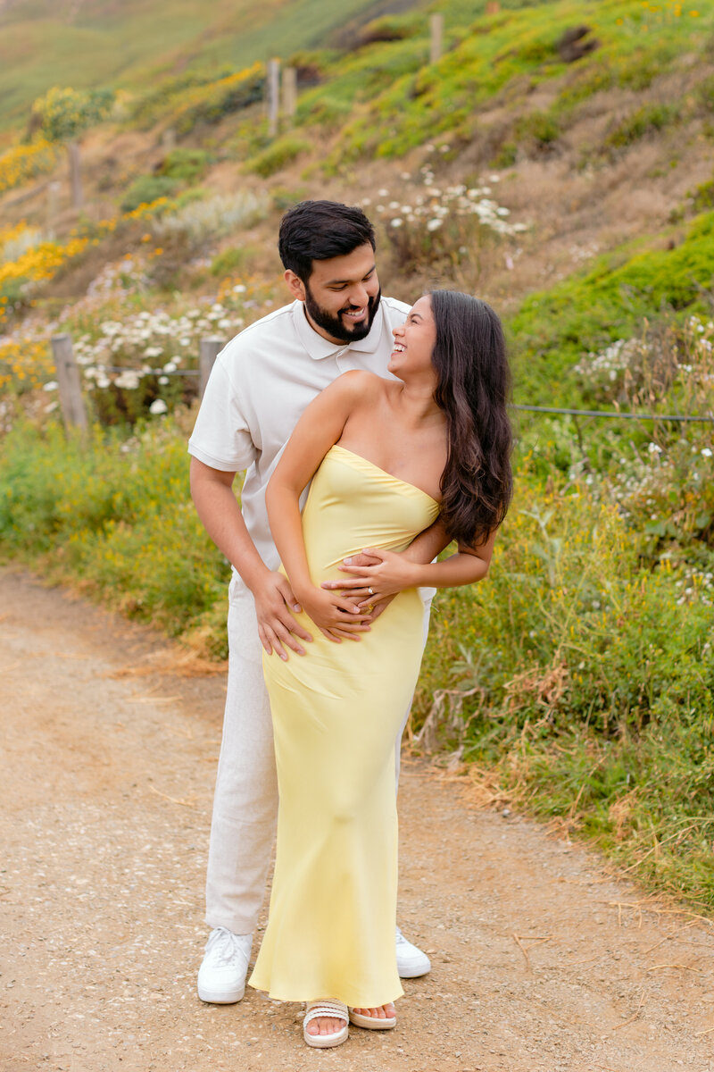 A sweet couple laughs together at their destination engagement session, photographed by K.Ranae Photography.