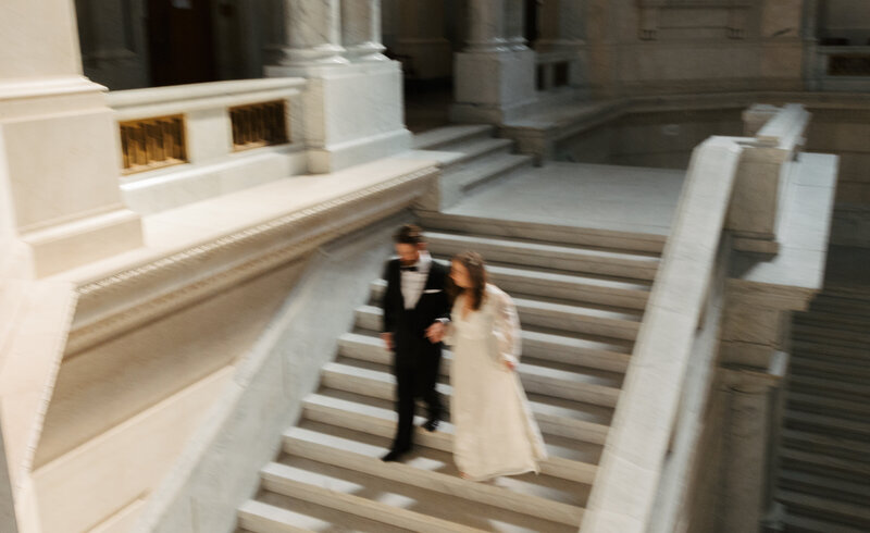 Couple walking down courthouse steps after elopement