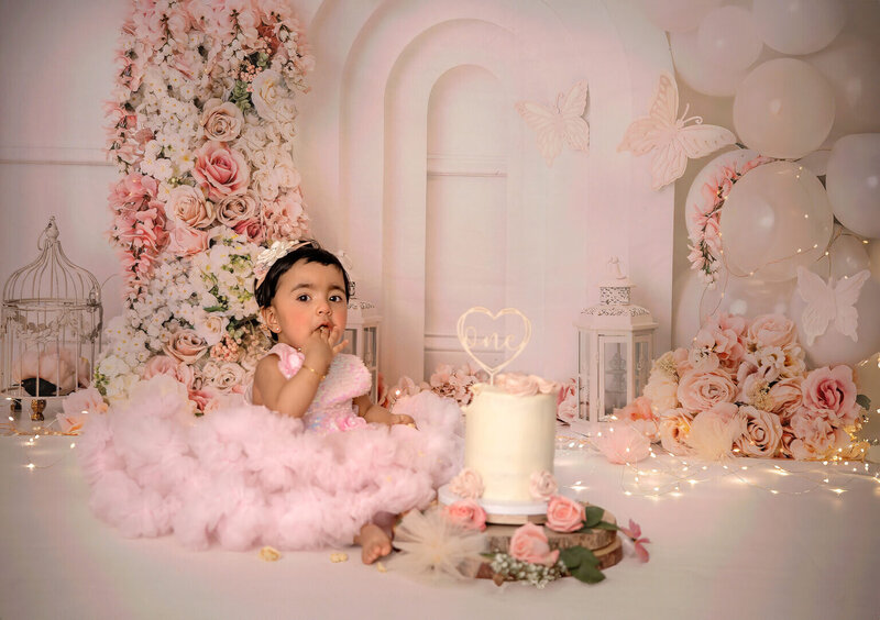 "Ottawa cake smash – happy one-year-old enjoying a messy celebration in studio"