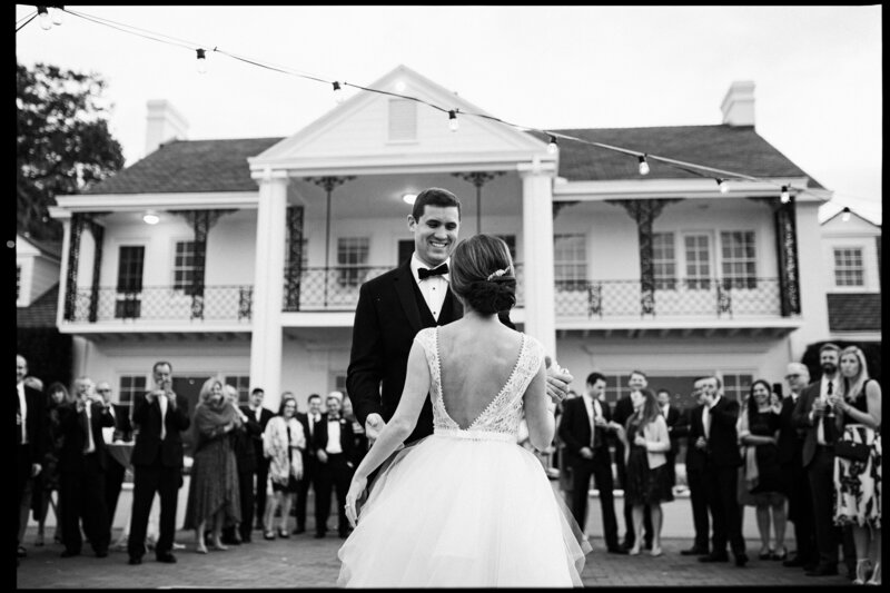 Father-of-the-bride walks the bride down the aisle while guests stand and observe during wedding ceremony at Vero Beach Resort and Spa.