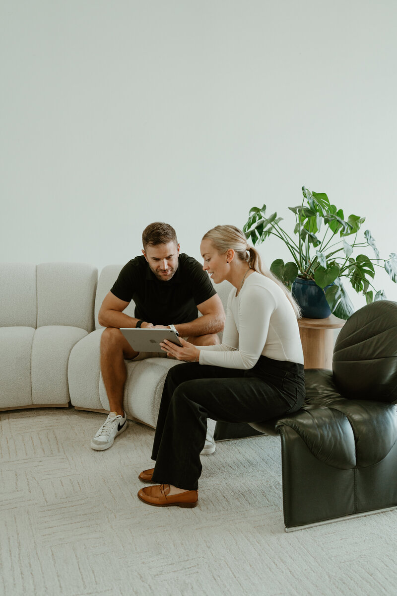 woman showing man chiropractic options and consulting
