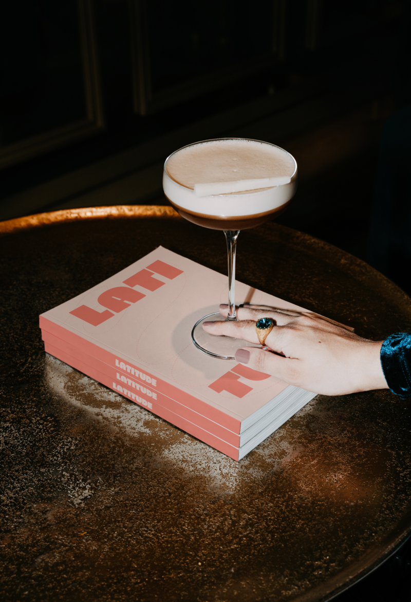 Cocktail on top of stacked Latitude Lane books