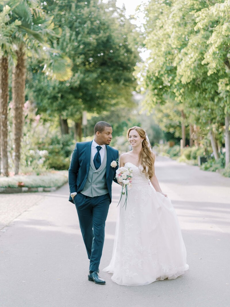 bride-and-groom-in-front-of-flower-arch