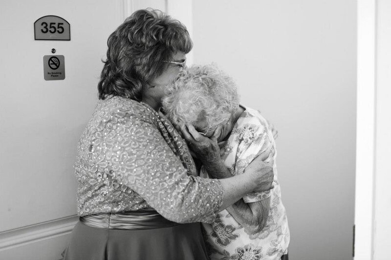 Two older women hugging.
