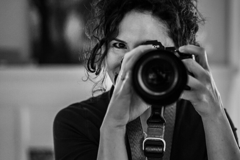 Kate Simpson, a Minneapolis photographer, behind her camera, just as you might see her during a family photo session.