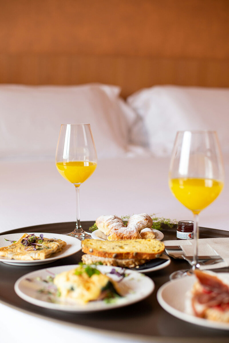 Table with plates of food and glasses of orange juice