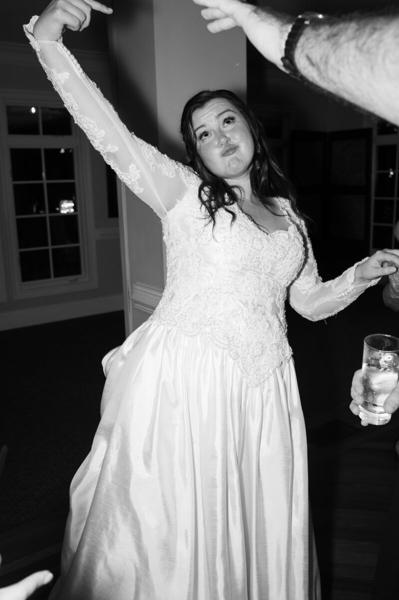 A bride dancing with guests at her reception