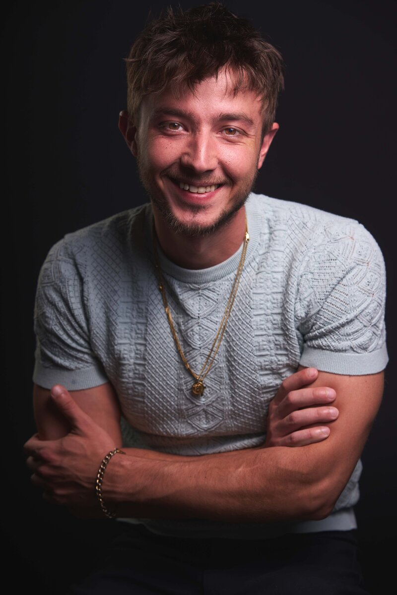 jon is staring inot the camera and smiling in my home studio