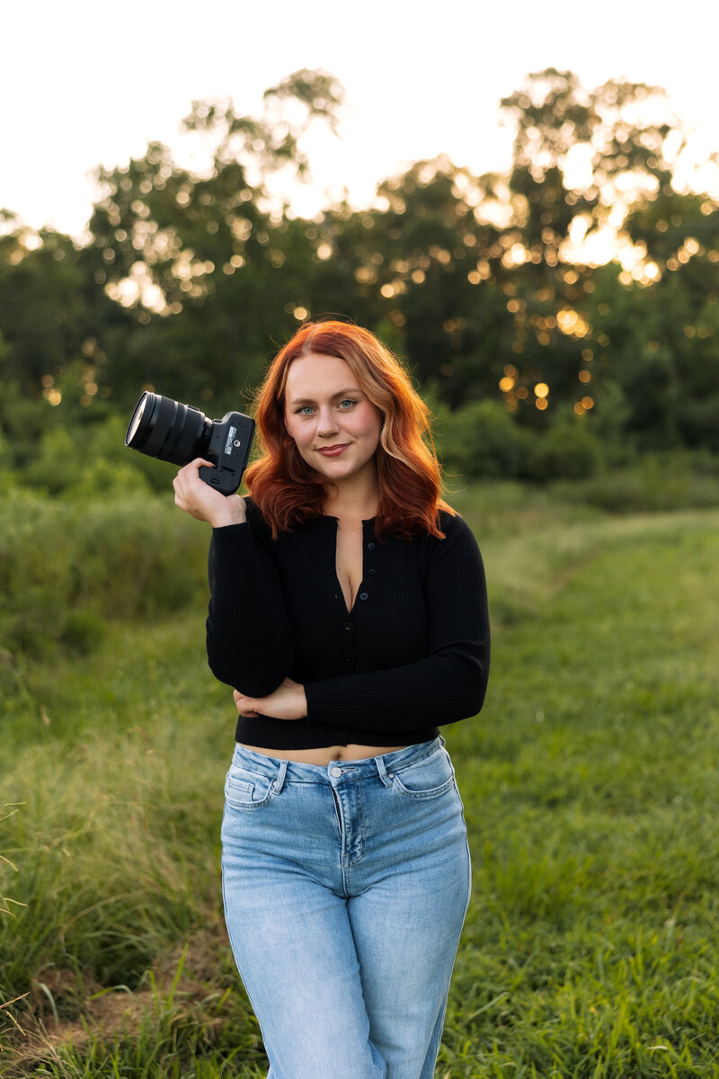 Madison McKenzie Holmes in a field, smiling at the camera for a headshot.