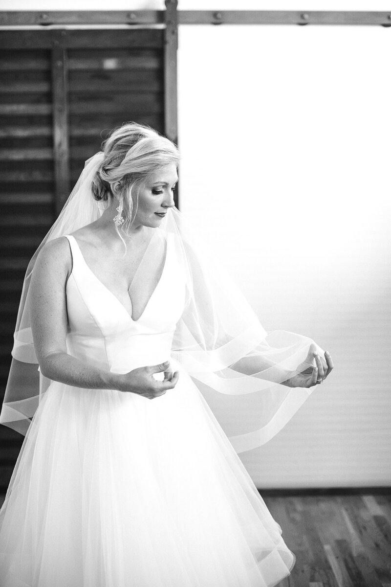 bride holding the veil by Knoxville Wedding Photographer, Amanda May Photos