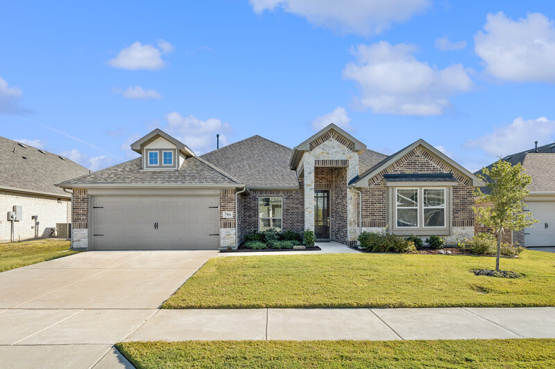 Charming brick ranch-style home with covered front porch, symmetrical windows, mature trees, and tiered walkway for curb appeal goals.